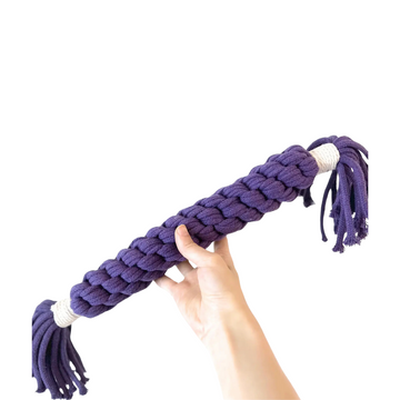 A purple large candy-shaped pet toy woven with cotton rope. It is soft, colorful, and designed to keep your pet entertained and engaged. Ideal for play and interaction.