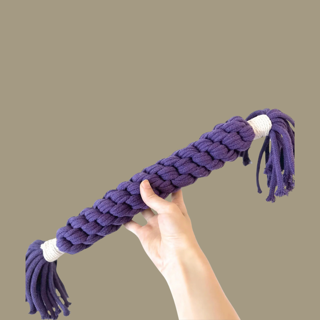 A purple large candy-shaped pet toy woven with cotton rope. It is soft, colorful, and designed to keep your pet entertained and engaged. Ideal for play and interaction.